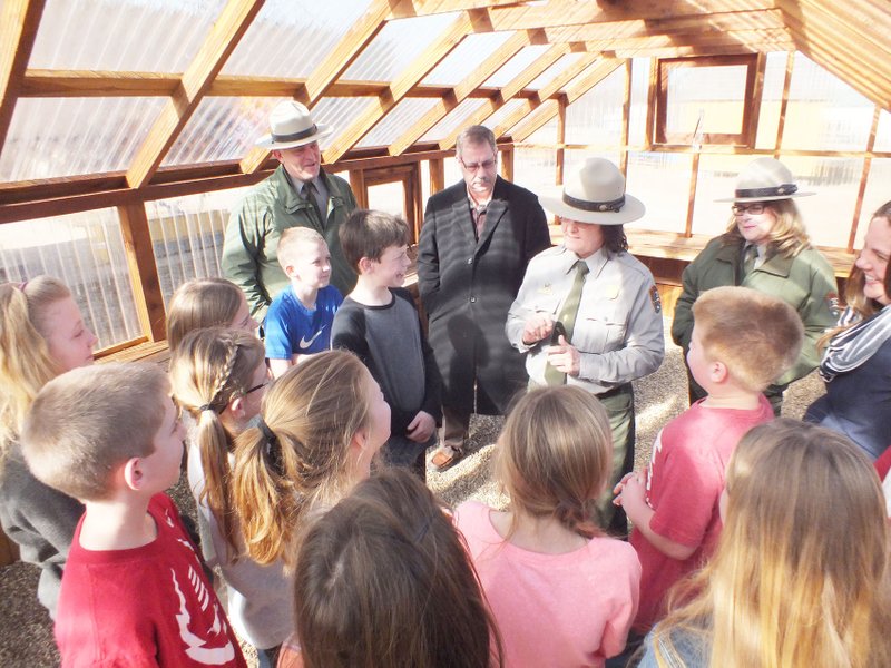 TIMES photograph by Annette Beard Pea Ridge fourth-grade students of Mrs. Brandy Knight and rangers from the Pea Ridge National Military Park visited in the new greenhouse on the Intermediate School campus. Sherry Nodine, Penny Schwitters and Kevin Eads, acting superintendent, visited with the students about heirloom plants and the potential for the greenhouse. Assistant school superintendent Keith Martin and Mayor Jackie Crabtree were also present.