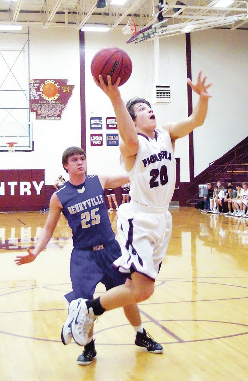 Photo by Randy Moll Cole Cripps, Gentry sophomore, got past Tate Ferguson, a Berryville defender, for a shot under the basket during play between the two teams in Gentry on Jan. 27.