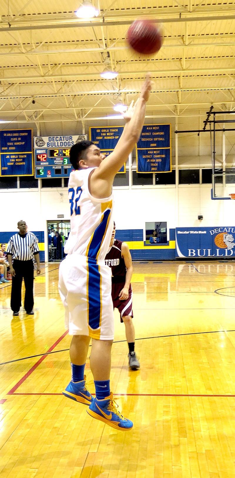 Photo by Mike Eckels Decatur&#8217;s Meng Vang attempts a jumper from the baseline during the Decatur-Hartford matchup Jan. 30 in the Dawg Pound at Decatur High. This was one of two shots Vang made in the second half, adding to the Bulldogs&#8217; 57 to 23 victory over the Hustlers.