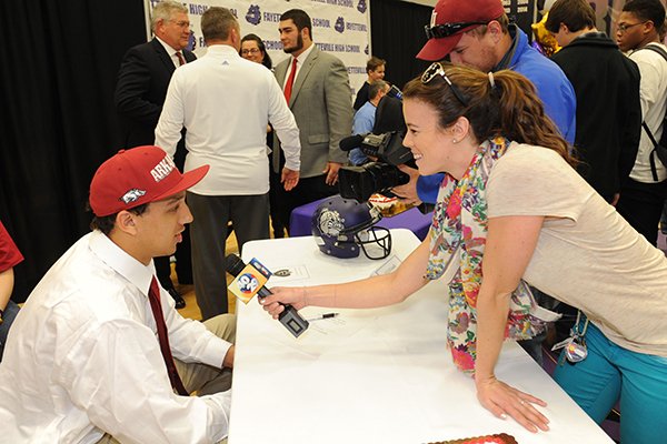 C.J. O'Grady speaks to reporters after signing to play football with the University of Arkansas during a signing ceremony Wednesday, Feb. 4, 2015, at Fayetteville High School.