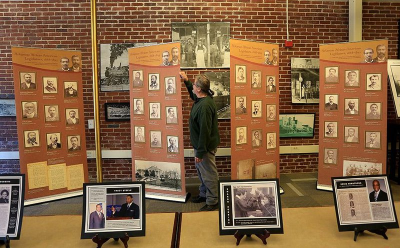Historian Cary Bradburn examines the “Arkansas African American Legislators, 1868-1893” exhibit at the North Little Rock History Commission, 506 Main St., on Thursday. The exhibit is free and open to the public Monday through Friday, 10 a.m.-4:30 p.m., through Feb. 27.  