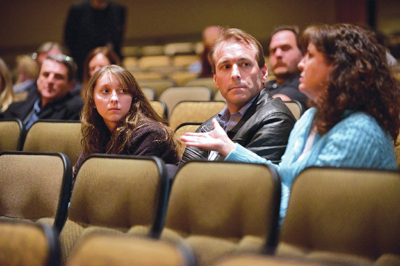 NWA Democrat-Gazette/BEN GOFF Rhianna Lightle, 15, a sophomore at Bentonville High, and father Grant Lightle, a Bentonville School Board member, listen Thursday as Stephanie Lightle poses a question Thursday during the School District&#8217;s informational meeting for families regarding the new West High School, which is scheduled to open August 2016.