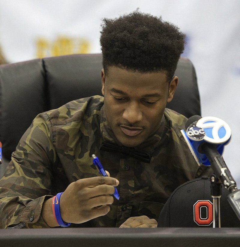 FILE North Little Rock’s K.J. Hill officially signs his national letter of intent to play for Ohio State on Wednesday morning inside the school’s gymnasium.