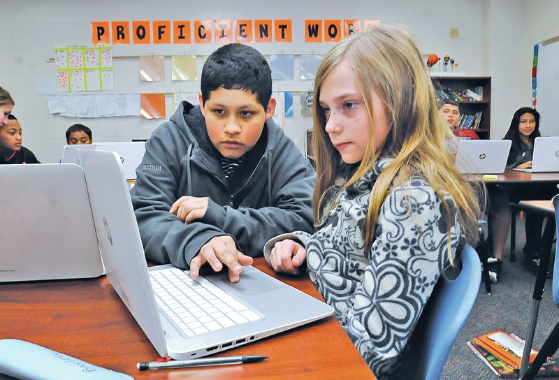  NWA Democrat-Gazette/FLIP PUTTHOFF Jonathan Mendez (left) and Baylee Clements work together on a math project Friday at Sonora Middle School.