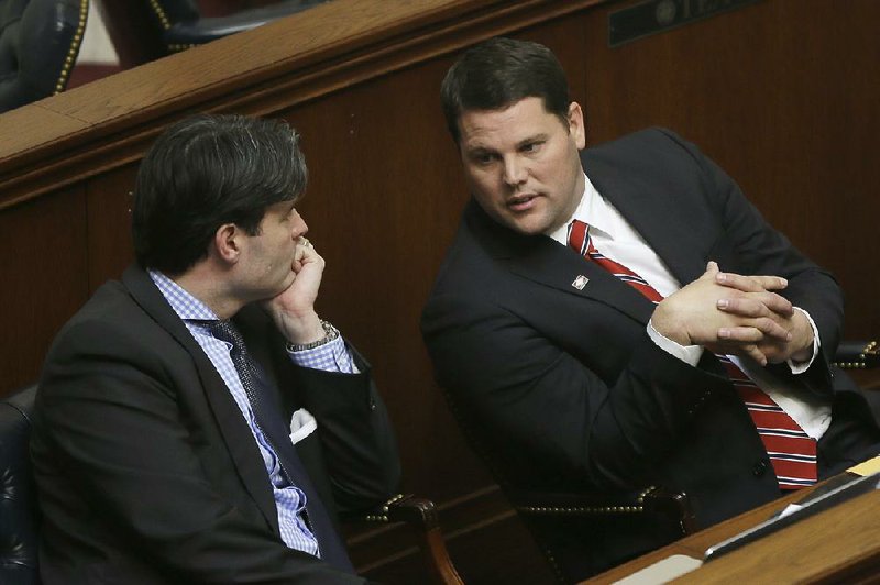 Sen. Bart Hester, R-Cave Springs, right, talks with Sen. David Sanders, R-Little Rock, in the Senate at the Arkansas state Capitol in Little Rock, Ark., Monday, Feb. 9, 2015. The Senate approved a bill by Hester to prohibit cities and counties from enacting ordinances that prohibit discrimination on a basis not contained in state law. (AP Photo/Danny Johnston)