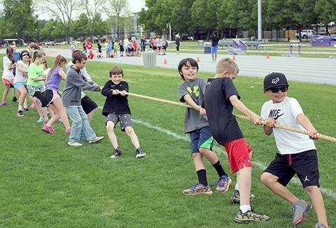 Special to the Democrat-Gazette/SUZANNE LAND
Dover Elementary School fourth-graders play tug-of-war during the 2014 Great Arkansas Workout at the University of Central Arkansas track complex in Conway.
