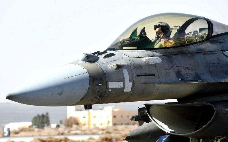 A United Arab Emirates fighter pilot mans an F-16 on Tuesday at an air base in Jordan in this photo from the UAE news agency WAM. Planes from UAE carried out airstrikes against Islamic State positions for the first time in weeks in a show of support for Jordan. 