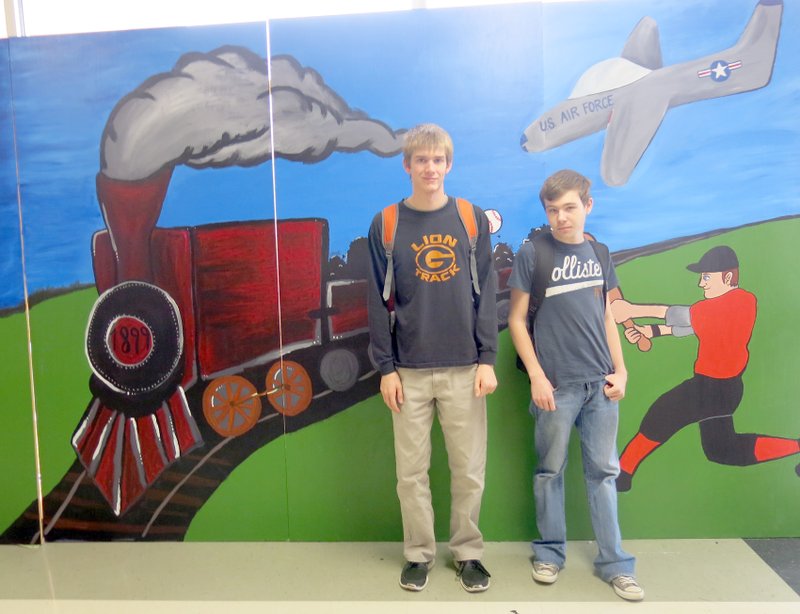 Photo by Susan Holland Austin Moon and Tyler Halpin were two of the Art II students who painted an early-day train engine for the mural depicting Gravette area history. A baseball player and a U.S. Air Force plane reflect the lives of prominent persons who called Gravette home. For the full story and more photos, see Page 6A.