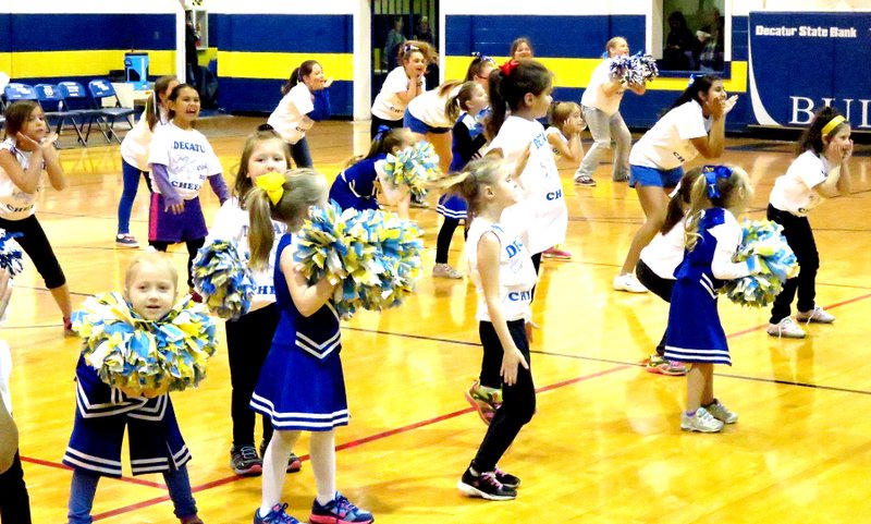 Photo by Mike Eckels Youth from kindergarten through grade seven performed at halftime during the Decatur-Mountainburg senior boys&#8217; game Feb. 6 in the gym at Decatur High School. The performance was the culmination of a three-day peewee cheer clinic held at Northside Elementary.