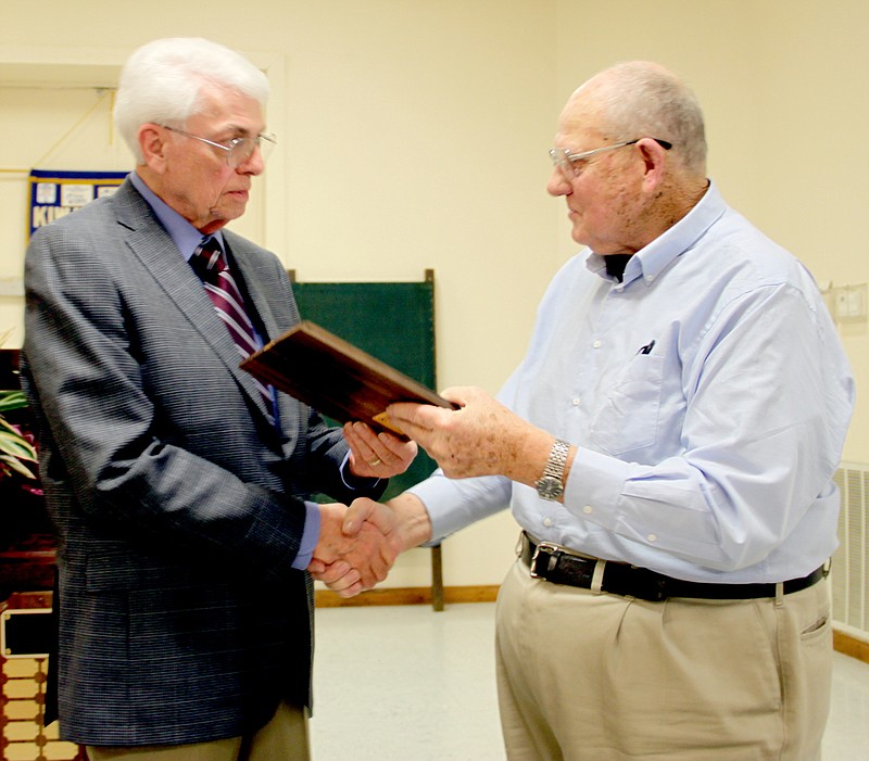 LYNN KUTTER ENTERPRISE-LEADER David Therneau, right, vice president with Lincoln Area Chamber of Commerce, congratulates John Harvey for receiving the 15th Bud Cox award at the annual Chamber banquet Friday night.