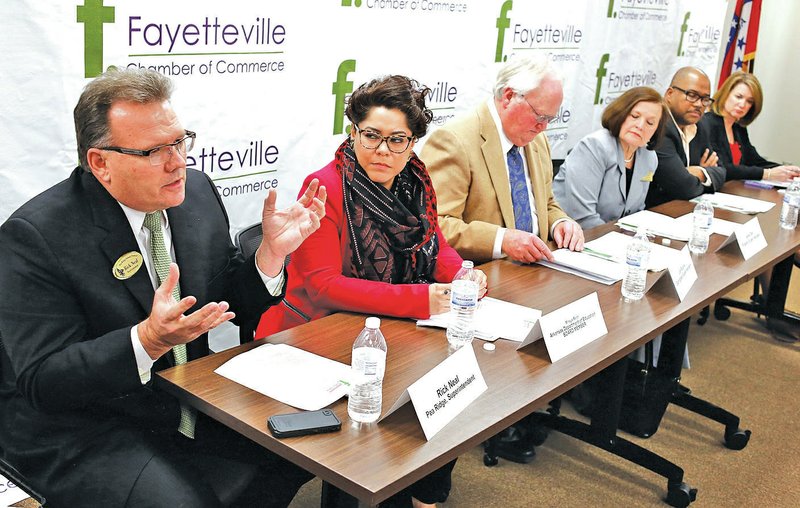 NWA Democrat-Gazette/DAVID GOTTSCHALK Rick Neal (from left), superintendent of Pea Ridge School District, sits Friday with Mireya Reith, Arkansas Department of Education board member, Jim Rollins, superintendent of Springdale School District, Janie Darr, superintendent of Rogers School District, Kim Davis, Arkansas Department of Education board member, and Kim Garrett, associate superintendent of Fayetteville Schools, listen during the Government Relations Committee meeting at the Fayetteville Chamber of Commerce. The panel participated in a discussion about workforce development efforts in Northwest Arkansas.