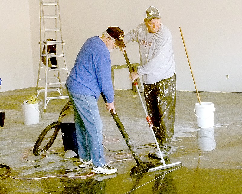 Lynn Atkins/The Weekly Vista Volunteers Rod Gibbens and Ed Lemerise clean up after the walls at Sensibly Chic II were dry walled. The new store won&#8217;t be a consignment shop like its predecessor. Instead it will support a new nonprofit, Audrey&#8217;s Home of Hope, that will serve pregnant women in crisis. The nonprofit is working towards matching a grant from a local man who wants to see them buy a home to house the women.