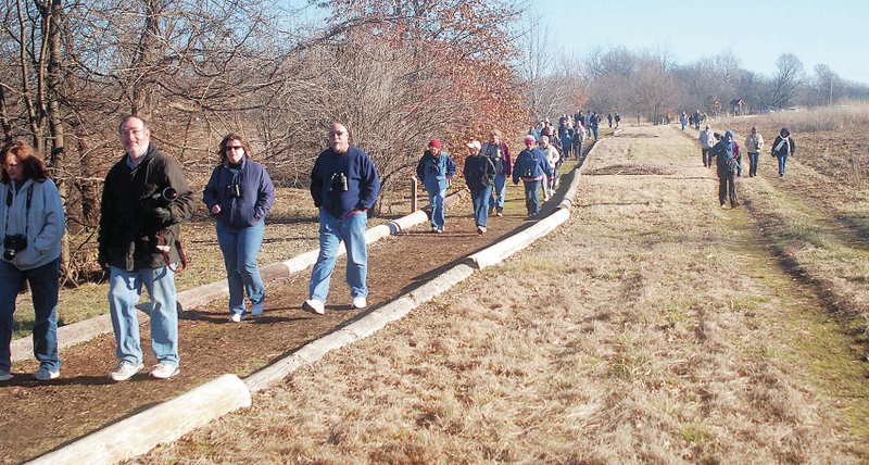 Photo by Terry Stanfill About 60 people, the largest group so far, attended the bird watching outing of the Northwest Arkansas Audubon Society at the Eagle Watch Nature Area on Saturday morning. The group came to see eagles and other birds commonly seen along the Eagle Watch Trail.