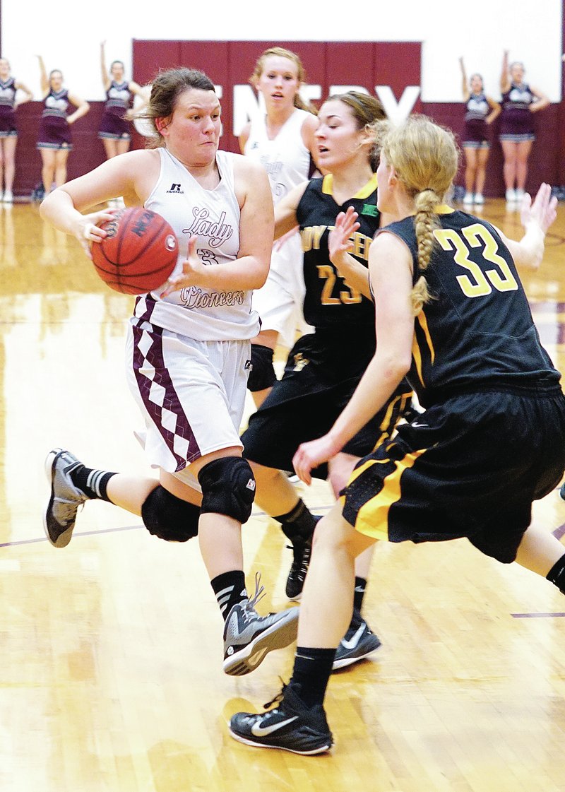 Photo by Randy Moll Rachel Lawrence, Gentry senior, tries to get past Prairie Grove defenders for a shot under the basket during play in Gentry between the two teams on Friday.