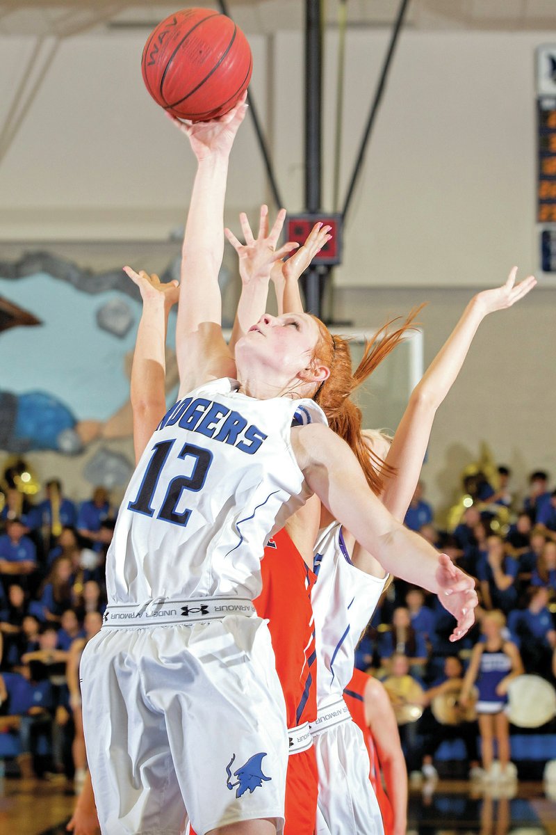 NWA Democrat-Gazette/JASON IVESTER Elise Randels, Rogers High sophomore, pulls down a rebound Tuesday against Rogers Heritage at King Arena. See more photos at nwadg.com/photos.