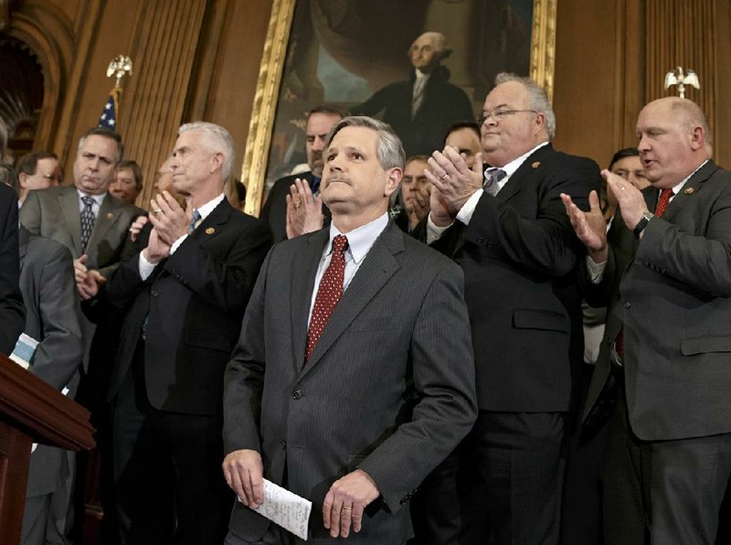Fellow lawmakers applaud Sen. John Hoeven (center), R-N.D., sponsor of the Senate’s Keystone XL pipeline bill, as they urge President Barack Obama to sign legislation backing the project that was approved in the Senate and House on Wednesday. 
