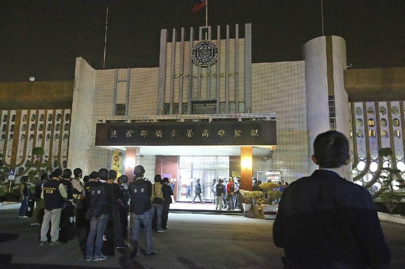 Police gather Wednesday outside a prison in Kaohsiung, Taiwan, as inmates held hostages inside. 