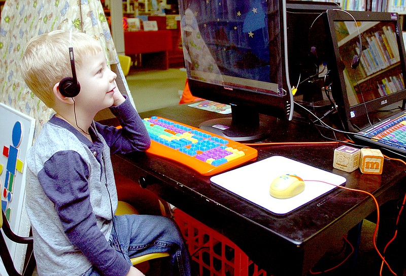RICK PECK MCDONALD COUNTY PRESS Jacob Manley, 4, of Noel uses a computer at the McDonald County Library in Pineville. Manley was at the library for a special program offered to home school children.