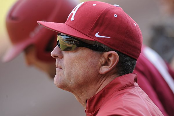 Arkansas coach Dave Van Horn watches from a dugout during practice Friday, Jan. 23, 2015, at Baum Stadium in Fayetteville.