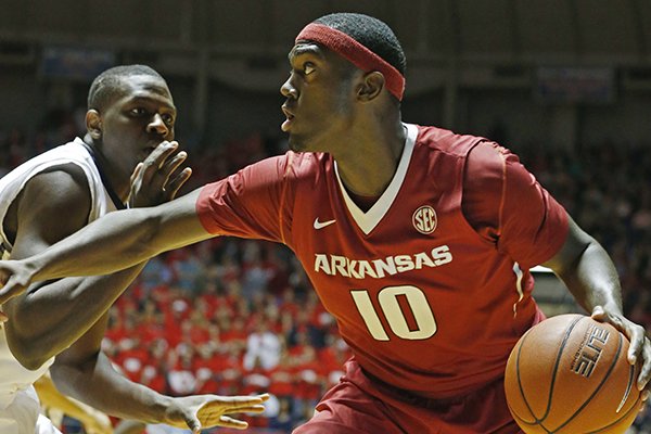 Arkansas forward Bobby Portis (10) dribbles past Mississippi center Dwight Coleby during the first half of an NCAA college basketball game in Oxford, Miss., Saturday, Feb. 14, 2015. (AP Photo/Rogelio V. Solis)