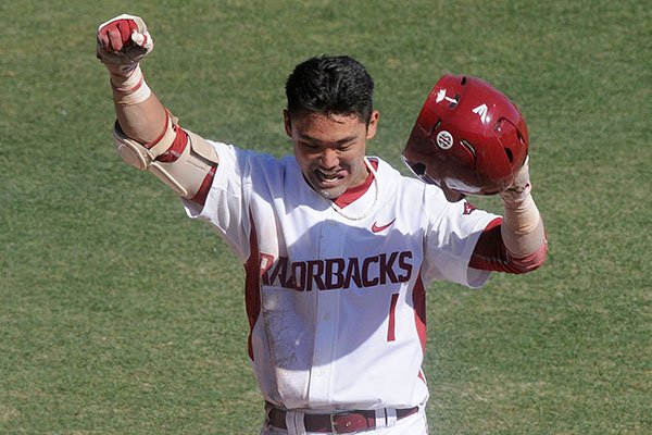 Arkansas second baseman Rick Nomura celebrates after scoring on an inside the park home run during a game against North Dakota on Saturday, Feb. 14, 2015, at Baum Stadium in Fayetteville. 