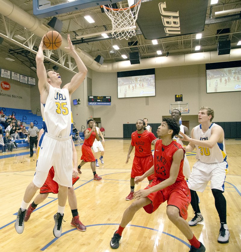 Kelsey Young/JBU Sports Information John Brown University senior forward Max Hopfgartner goes up for the shot against Mid-America Christian on Thursday at Bill George Arena. The Evangels defeated the Golden Eagles 84-74.
