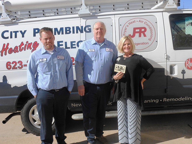 Submitted photo &#8216;GIVING BACK&#8217;: Garry Williams, left, and Rick Bonte, of City Plumbing, Heating & Electric Inc., presented Laura Gregg, with Potter&#8217;s Clay Hot Springs Village Women&#8217;s Auxiliary, a donation of $1,150. The company has now donated more than $74,970 to local charities.