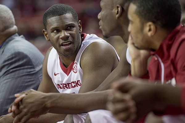 Arkansas forward Manuale Watkins, left, talks to a teammate on the bench after leaving the court during the second half of an NCAA college basketball game on Tuesday, Feb. 3, 2015, in Fayetteville, Ark. Arkansas defeated South Carolina 75-55. (AP Photo/Gareth Patterson)