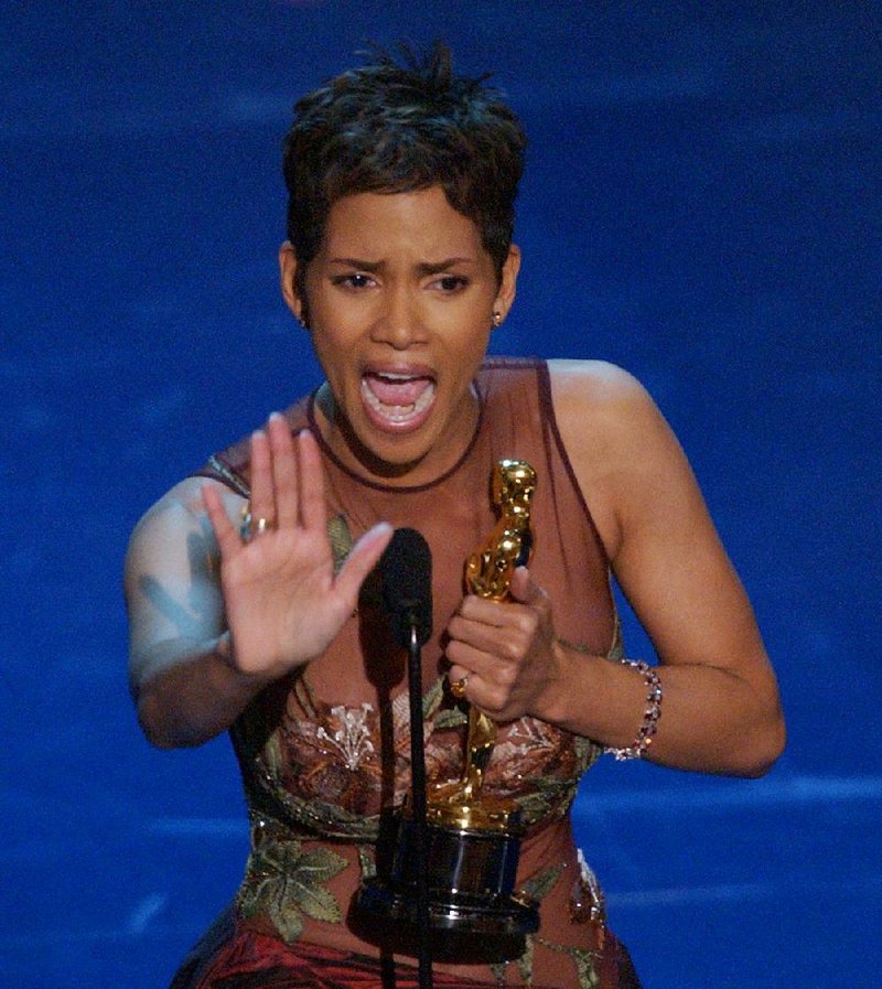 Actress Halle Berry puts her hand up after getting the signal to cut her speech off while accepting her award for best actress during the 74th annual Academy Awards Sunday, March 24, 2002, in Los Angeles. Berry won for her work in "Monster's Ball."  (AP Photo/Kevork Djansezian)