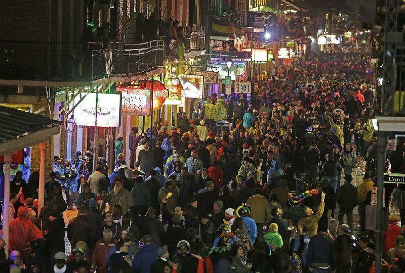 FILE - In this March 4, 2014 file, photo, revelers pack the French Quarter during Mardi Gras, as seen from the balcony of the Royal Sonesta Hotel in New Orleans. Mardi Gras falls on Feb. 17 this year. (AP Photo/Gerald Herbert, File)