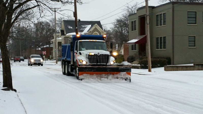 A snow plow runs at Sixth and Cumberland streets in downtown Little Rock on Monday, Feb. 16, 2015.