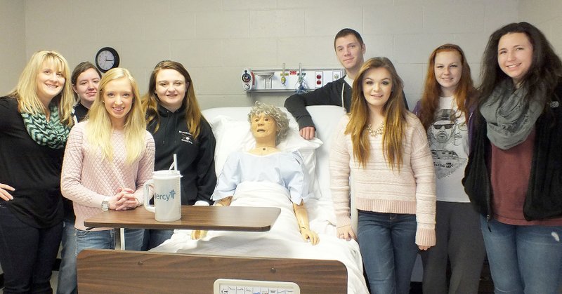 TIMES photographs by Annette Beard Teacher Elisha Escajeda and students Nikki Lusk, Ashley Rouse, Brittnee Sykes, Emily Austin, Austin Hicks, Kelsie Merritt, Dylan Kennedy and Lexi Losey with their &#8220;patient&#8221; on whom they&#8217;ve learned many lessons in their nursing program at PRMBA.
