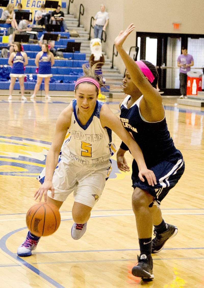 Kelsey Young/JBU Sports Information John Brown University junior Tristan Carrasquillo drives the lane while guarded by a Texas Wesleyan defender during Saturday&#8217;s game at Bill George Arena. Carrasquillo scored 12 points in the Golden Eagles&#8217; 65-59 victory.