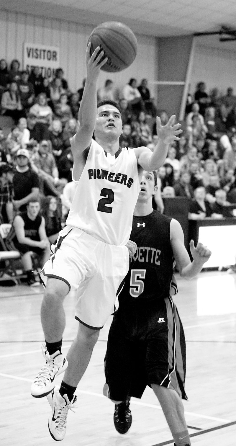 Photo by Randy Moll Wally Dane, Gentry junior, gets past Zac Carlton, Gravette senior, for a shot under the basket during play between the two rivals in Gravette on Friday.