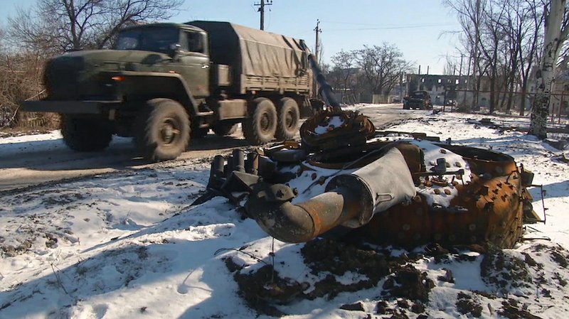 In this image made from TV, A truck drives past a destroyed tank as Russian backed rebel forces consolidate their position in Vuhlehirsk, Ukraine, on Wednesday Feb. 18, 2015, advancing on Debaltseve, about 2 miles from this position. The strategic town of Debaltseve has been the epicenter of recent fighting between the separatist and government troops in eastern Ukraine, despite the recent implementation of a ceasefire. 