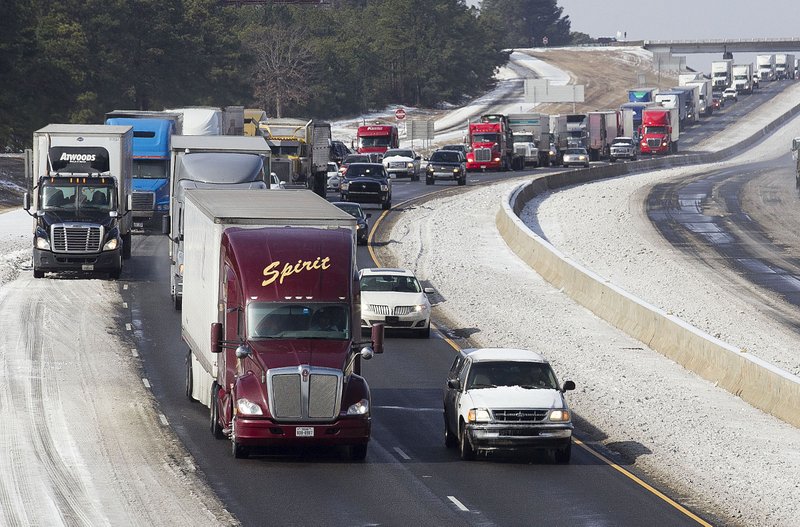 
Traffic backs up as drivers proceed cautiously down Interstate 30 near Geyer Springs as ice and slush begin to melt on Tuesday.