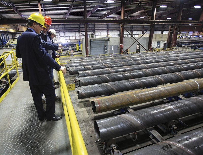  Congressman French Hill (left) and Welspun Tubular LLC President David Delie talk Tuesday afternoon as they tour company's Little Rock facility.