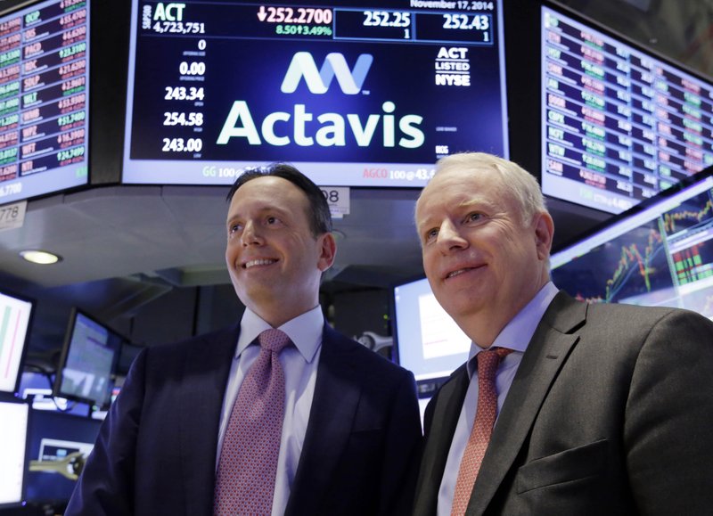 In this Nov. 17, 2014 file photo, Actavis CEO Brenton Saunders, left, and Allergan CEO David Pyott posse for a photo on the floor of the New York Stock Exchange. Actavis said Wednesday, Feb. 18, 2015 that it will adopt the Allergan corporate name after securing Actavis shareholders' approval for the switch at its annual meeting later this year.