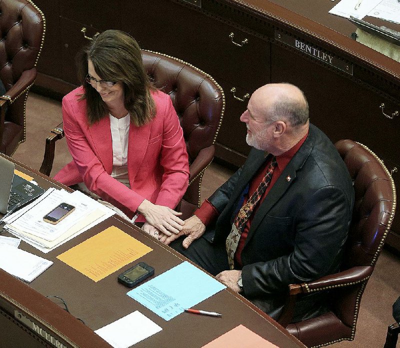 Rep. Mark McElroy, D-Tillar, congratulates Rep. Julie Mayberry, R-Hensley, after the bill she presented to ban the use of telemedicine during chemical abortions was approved Thursday in the House. 