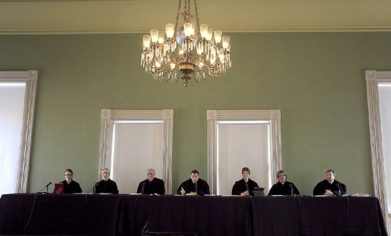 The Arkansas Supreme Court prepares to hear oral arguments in the Old State House Museum in Little Rock on Thursday. It has been a little over 100 years since they have convened in the building. The justices are (left to right), Rhonda Wood, Courtney Hudson Goodson, Paul Danielson, Chief Justice Jim Hannah, Karen Baker, Josephine Hart and Robin Wynne. 