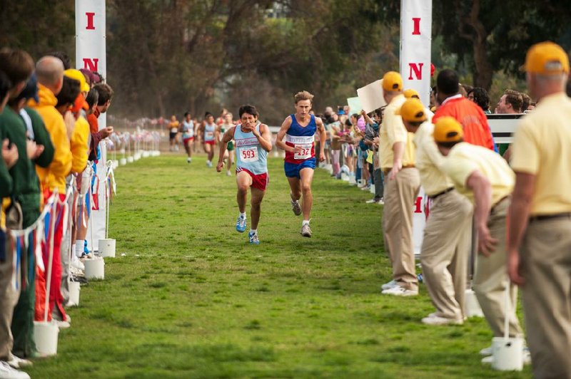 Thomas Valles (Carlos Pratts, left) goes into his kick to try to outrun a rival from a wealthier high school in McFarland, USA, based on the true story of a newly formed cross-country team in ’80s California.