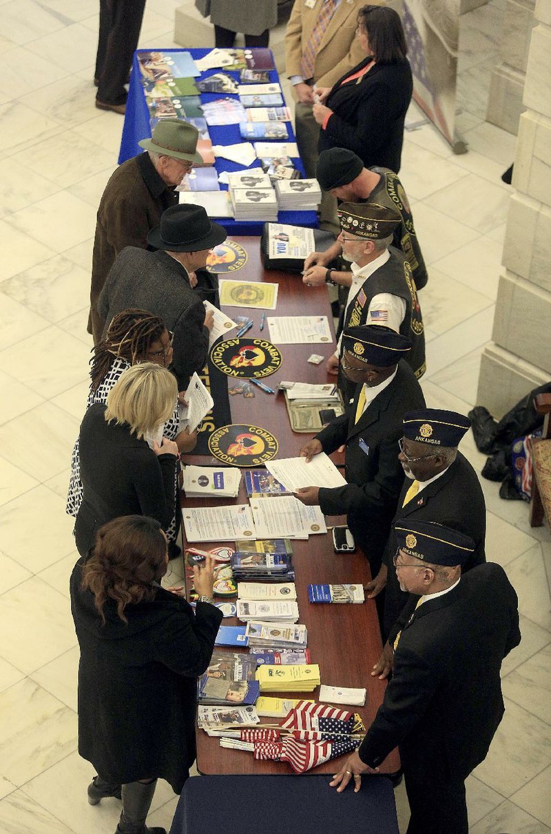 Representatives of various veterans organizations talk with veterans Thursday in the state Capitol rotunda as part of veterans service organizations day. 