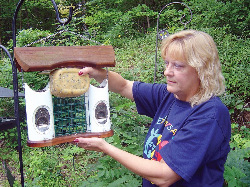 Theresa Sutton of Alexander uses a suet feeder to present her family’s homemade specialty foods to backyard birds. The blocks of food are molded in inexpensive plastic containers.
