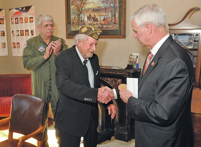 U.S. Rep. Steve Womack presents a bronze version of the Congressional Gold Medal to Manford “Manny” Redifer, 89, of Hackett, a World War II veteran who served in the Civil Air Patrol, during a Thursday ceremony in Fort Smith. 