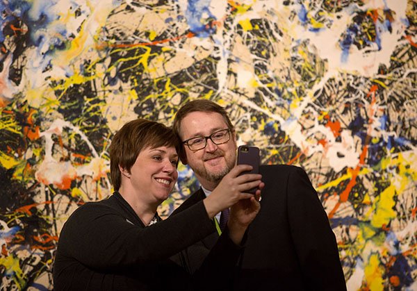 NWA Democrat-Gazette/JASON IVESTER --02/19/2015--
Crystal Bridges Museum of American Art staff members Niki Stewart and Jamey McGaugh take a "selfie" in front of Jackson Pollock's "Convergence" on Thursday, Feb. 19, 2015, during a media preview of the Van Gogh to Rotko exhibition inside the Bentonville museum. See more photos at nwadg.com/photos.