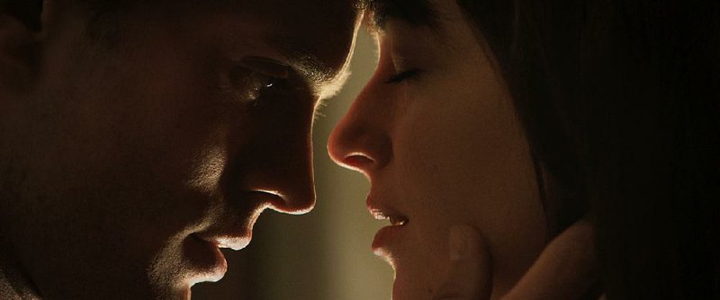 Jamie Dornan (left) and Dakota Johnson star in Fifty Shades of Grey.