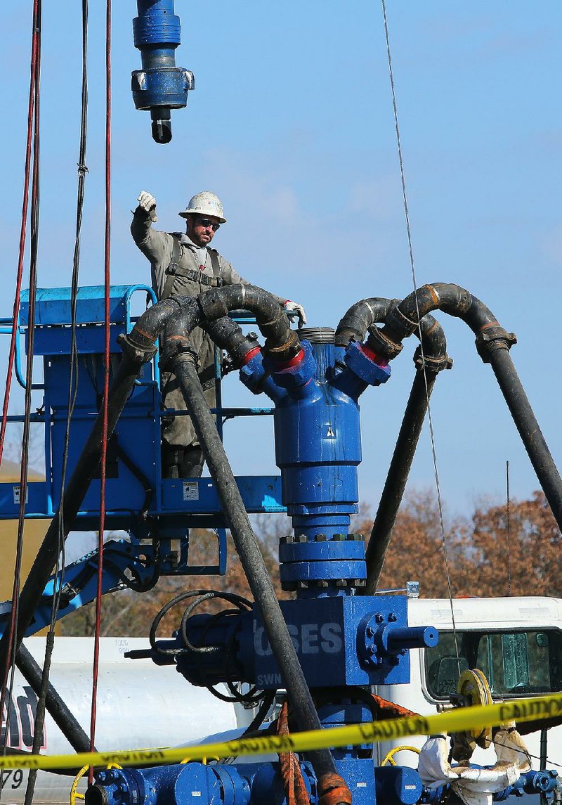 A Southwestern Energy worker rigs equipment at the top of a well head near Clinton in November.