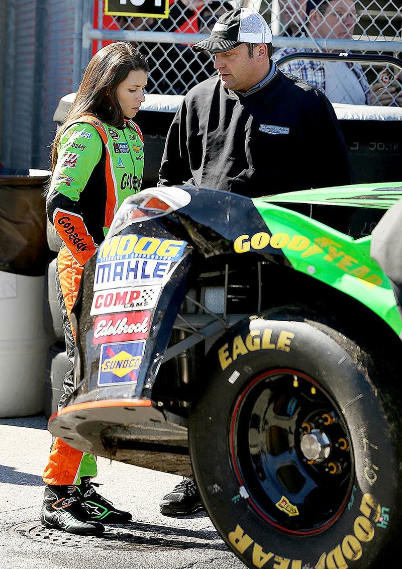 Driver Danica Patrick talks to Greg Zipadelli, competition director at Stewart-Haas Racing, after she crashed during Wednesday’s practice for the Daytona 500 at Daytona International Speedway in Daytona Beach, Fla. 