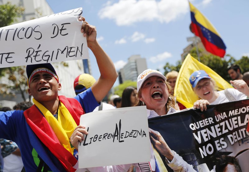 People chant slogans Friday demanding the release of Metropolitan Mayor Antonio Ledezma during a protest in Caracas, Venezuela. Demonstrators are condemning last night’s surprise arrest of the Caracas’ mayor for allegedly plotting to overthrow the government of President Nicolas Maduro.