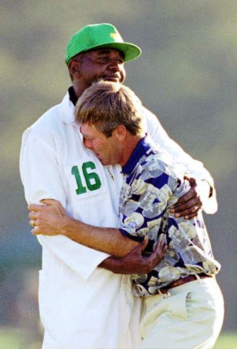 Ben Crenshaw hugs caddie Carl Jackson after winning the 1995 Masters in Augusta, Ga. Jackson, who will caddie for Crenshaw in April for the 39th time at the Masters, will be inducted into the Arkansas Sports Hall of Fame on Friday. 